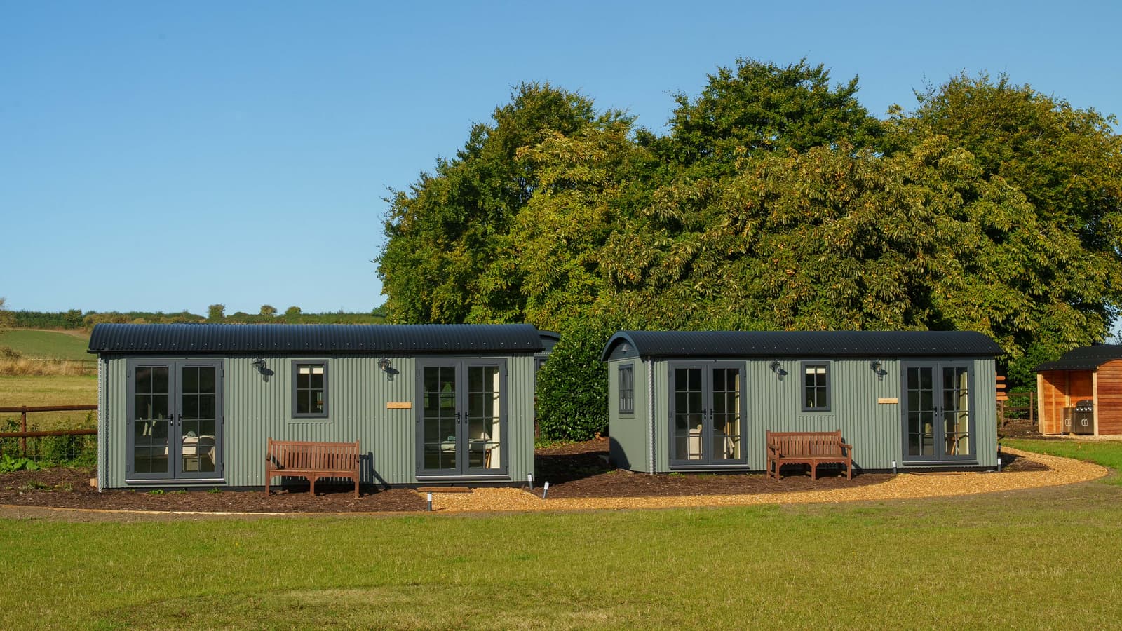 The Texel and Herdwick huts side by side on the green, identical twins
