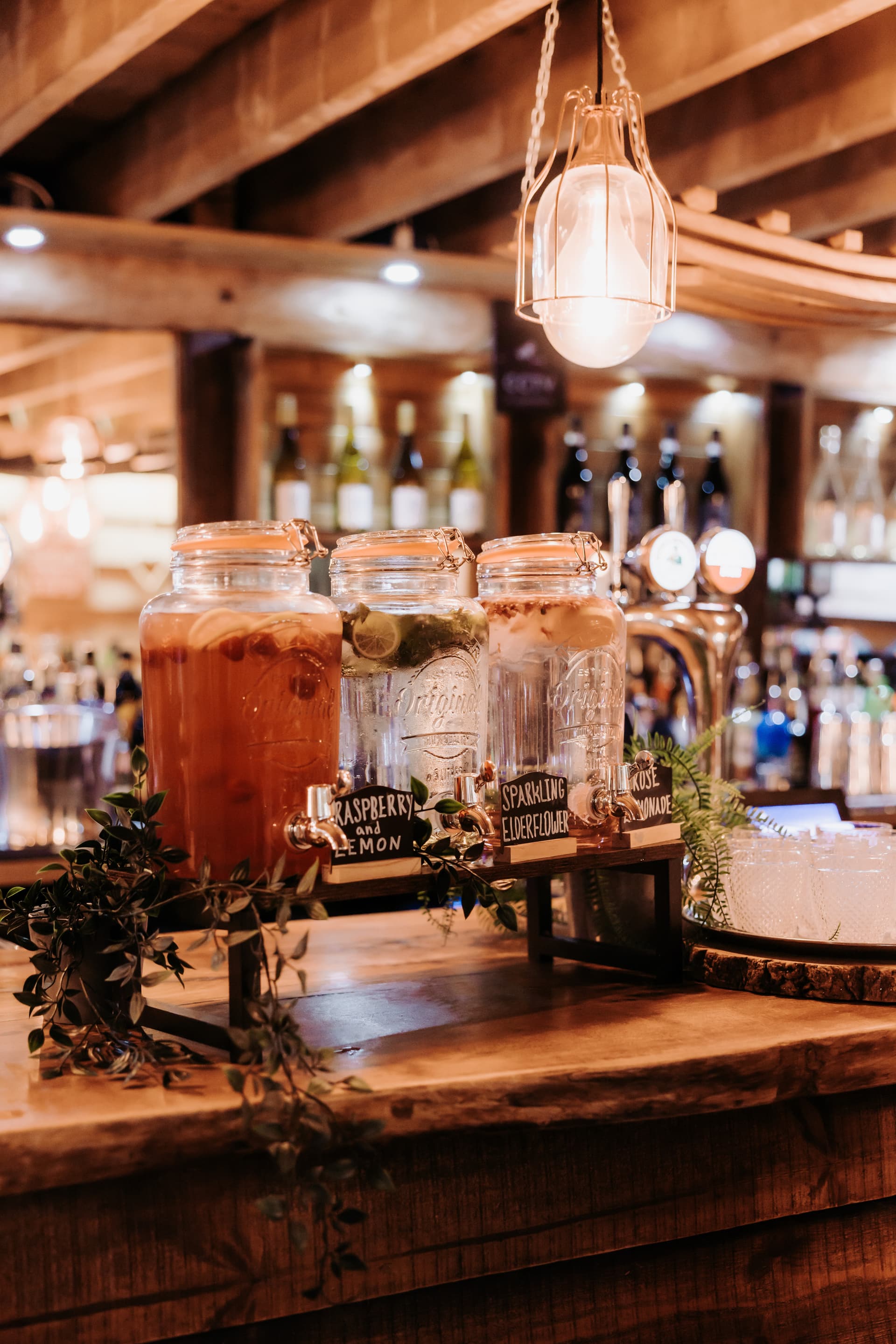 The rustic bar stocked and lit, drinks jars on the counter