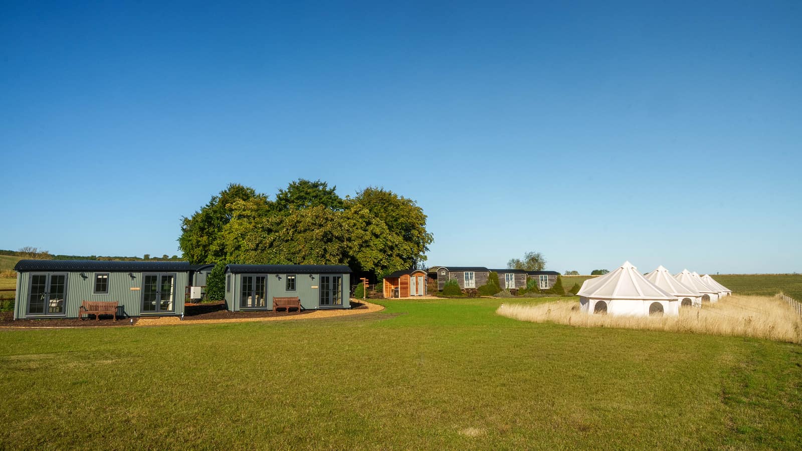 Bell tents and huts in the open field